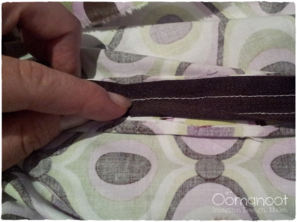 See how the raw edge of the fabric is under the zipper?